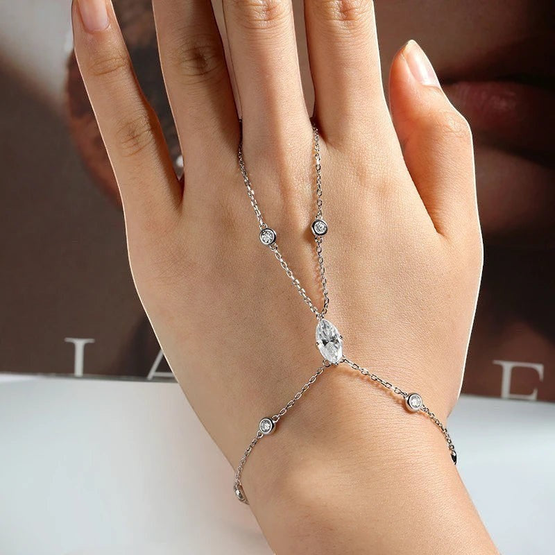 Bee-Bees 18k gold plated s925 sterling silver hand chain bracelet with a 2ct marquise cut moissanite and small accent stones.