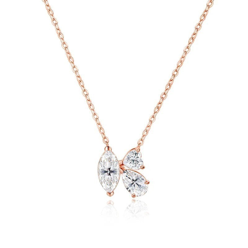 Bee-Bees rose gold necklace with three clear marquise and pear cut moissanite stones arranged in a cluster.