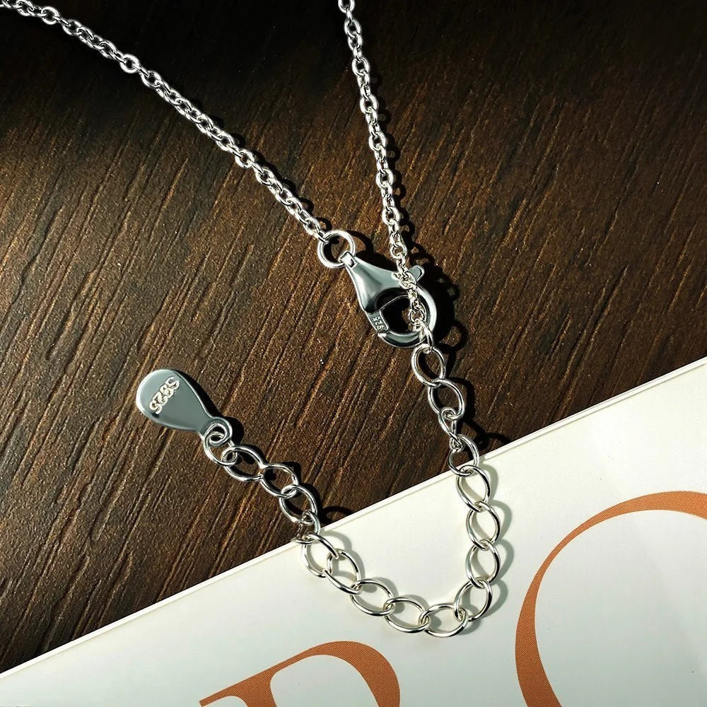 Bee-Bees Sterling silver necklace with adjustable chain and lobster clasp, featuring a marquise cut moissanite pendant.