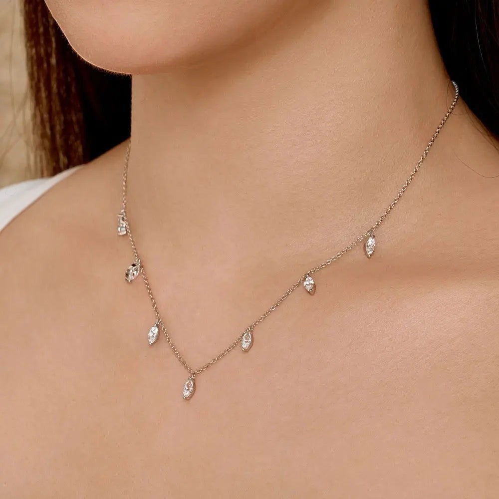 Bee-Bees sterling silver necklace with multiple small marquise cut moissanite stones spaced along a delicate chain.