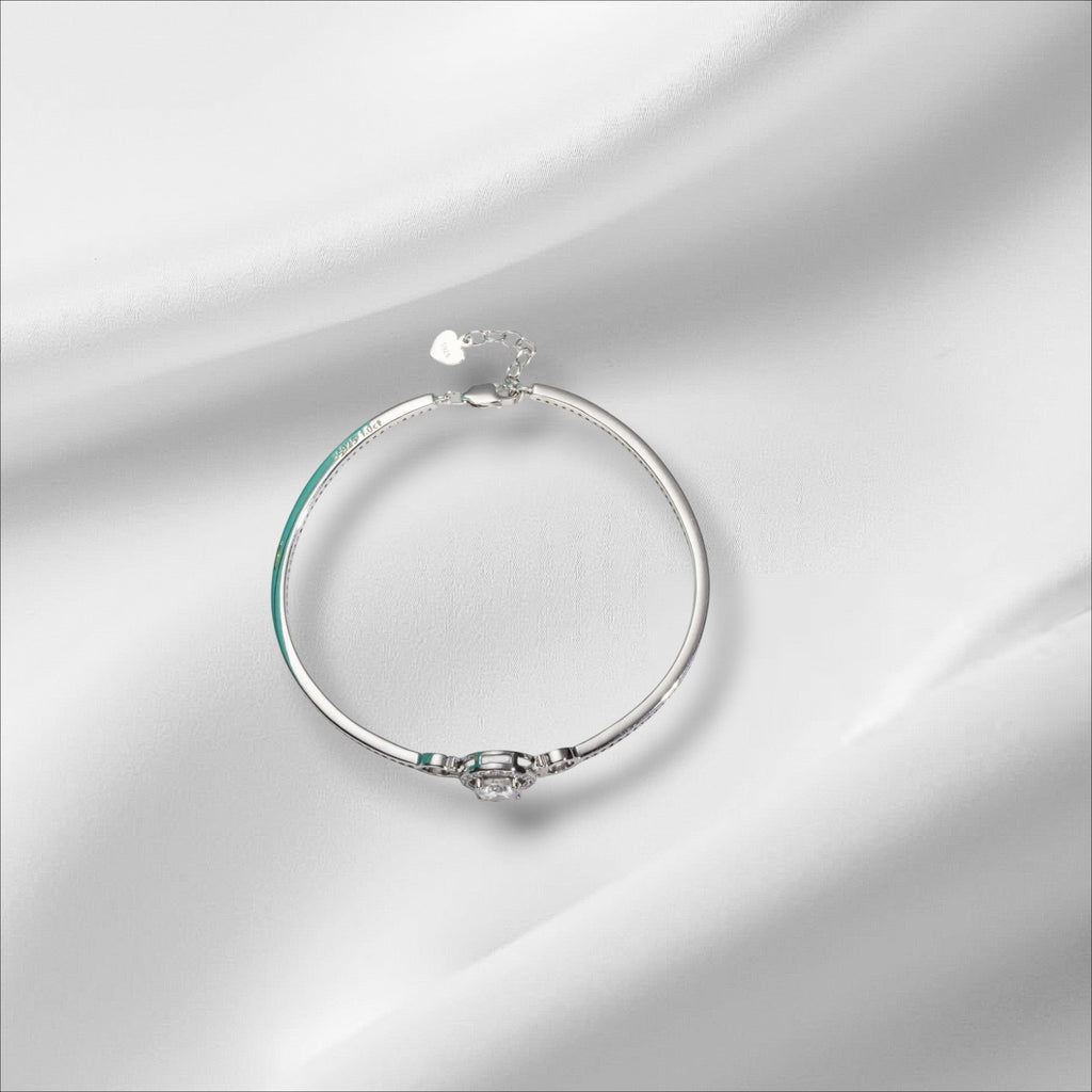 Bee-Bees 1ct Moissanite adjustable bangle in sterling silver with 18k white gold plating. Features a round brilliant cut D-color stone.
