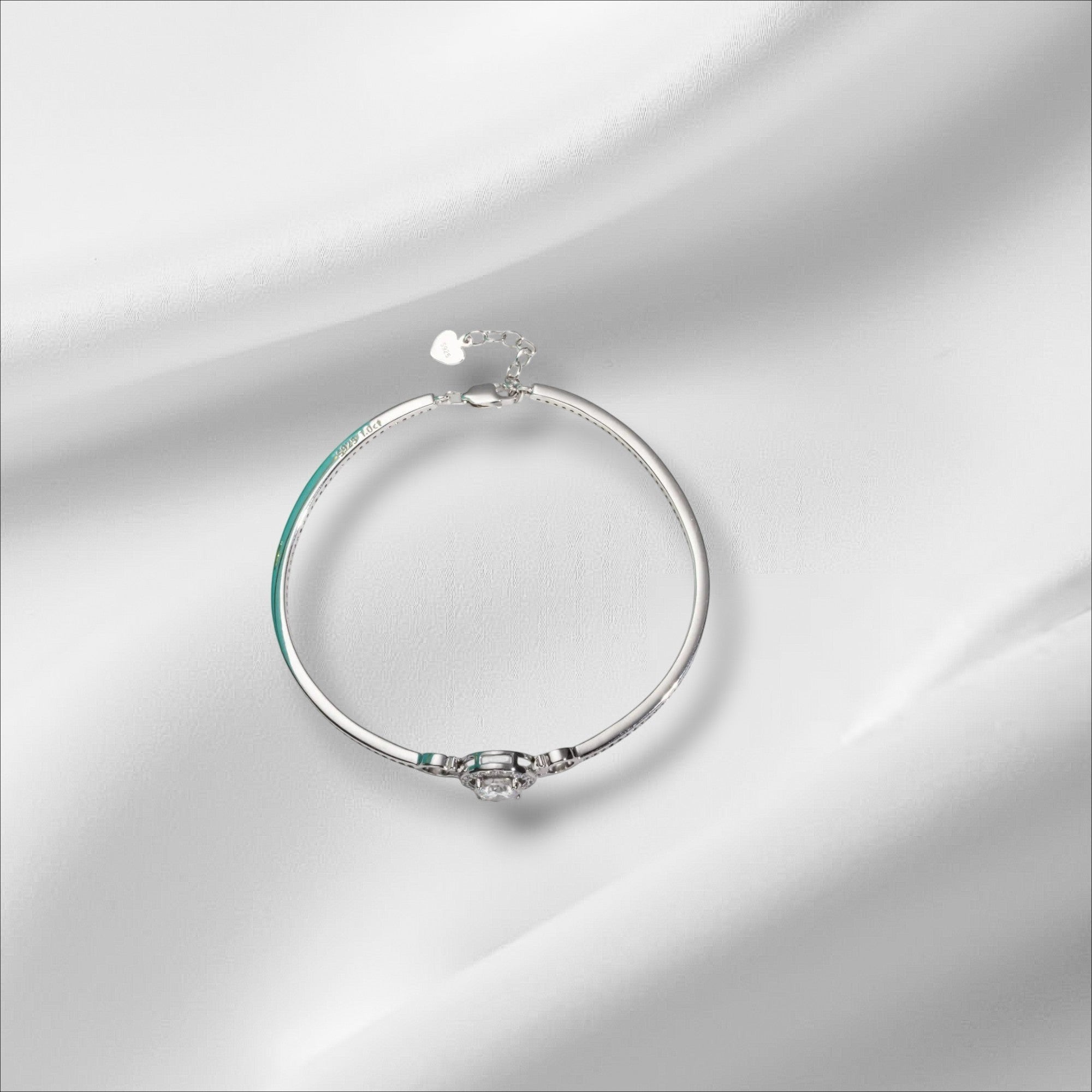 Bee-Bees 1ct Moissanite adjustable bangle in sterling silver with 18k white gold plating. Features a round brilliant cut D-color stone.