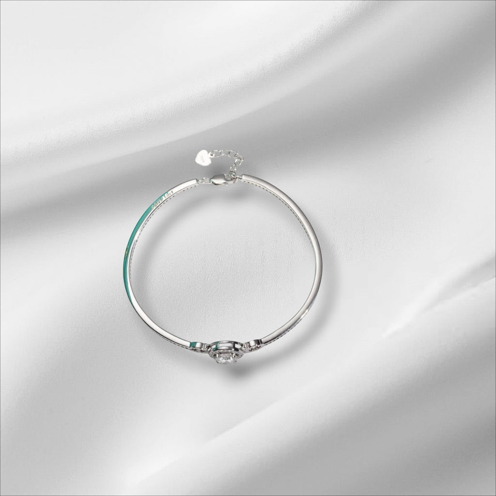 Bee-Bees 1ct Moissanite adjustable bangle in sterling silver with 18k white gold plating. Features a round brilliant cut D-color stone.