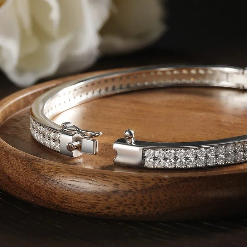 Bee-Bee's sterling silver bangle with 2mm D VVS1 moissanite stones, 18K gold plated, 6mm wide, with clasp closure.