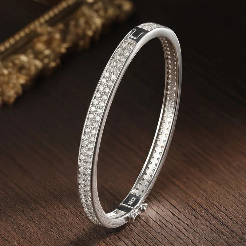 Bee-Bee's sterling silver bangle with full row of 2mm D Color VVS1 Moissanite stones, 18K gold plated, 6mm wide.