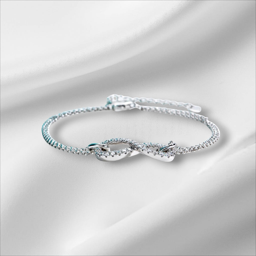 Bee-Bees Sterling silver bracelet with a bow-knot design encrusted with D VVS1 Moissanite stones. 18k gold plated.