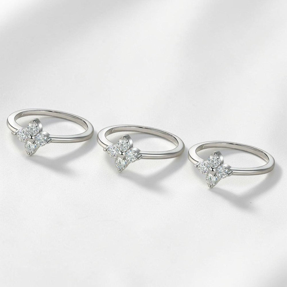 Bee-Bees sterling silver four-leaf clover wedding rings featuring brilliant D-color round-cut moissanite stones.