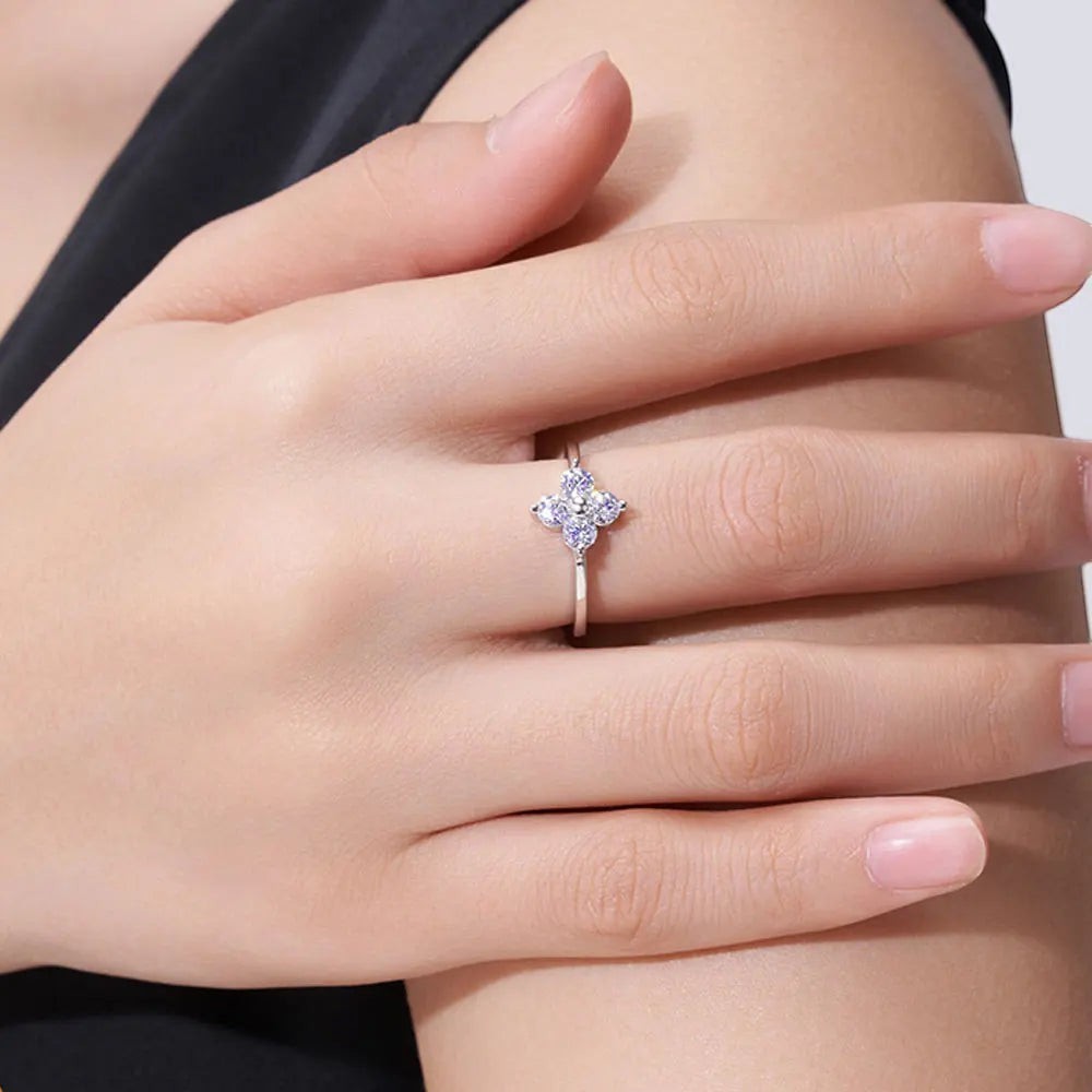 Bee-Bees sterling silver ring featuring a D-color moissanite four-leaf clover design worn on a woman's finger.