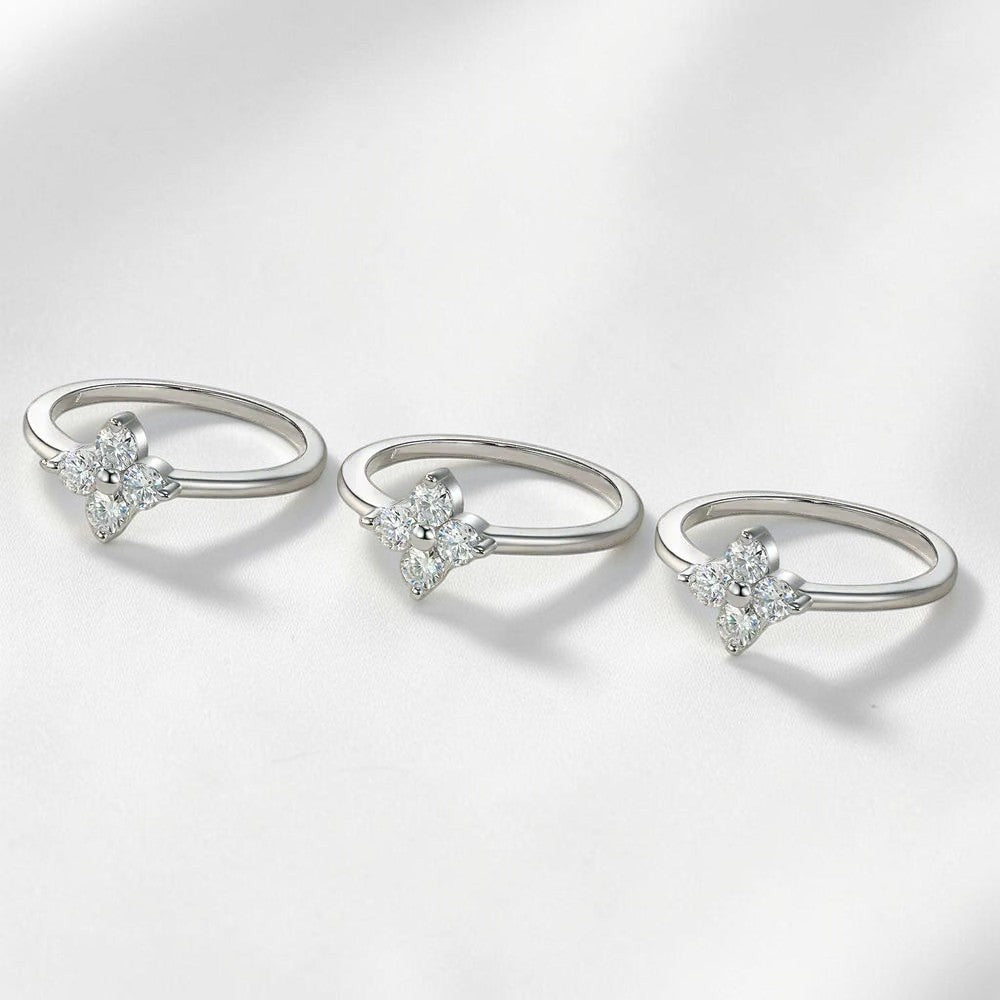 Bee-Bees sterling silver four-leaf clover wedding rings featuring brilliant D-color round-cut moissanite stones.