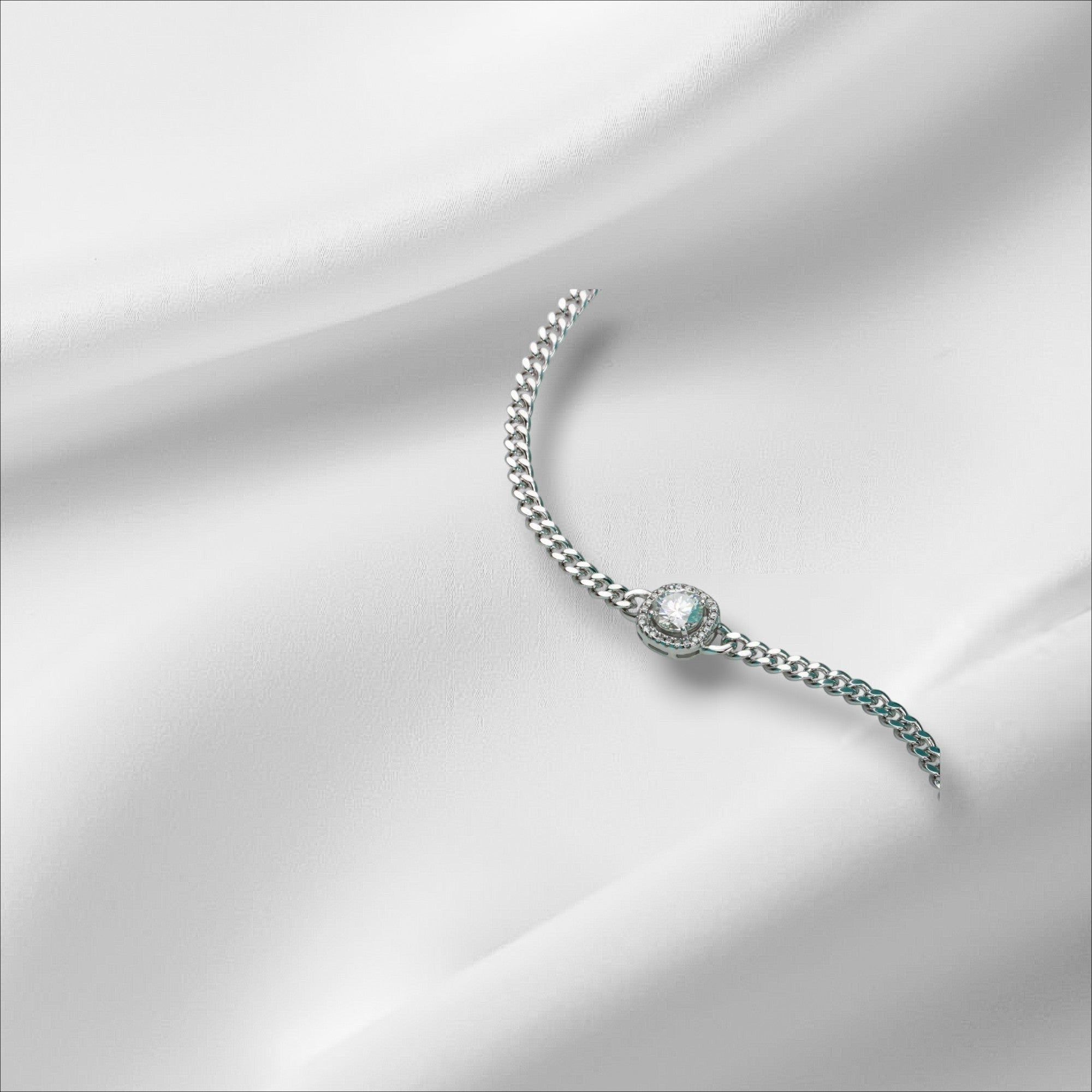 Bee-Bees Moissanite Cuban link bracelet in sterling silver with 18k white gold plating and a central round-cut stone.