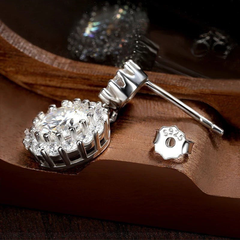Bee-Bees 1ct round cut moissanite drop earrings in S925 silver with halo setting and butterfly backs.