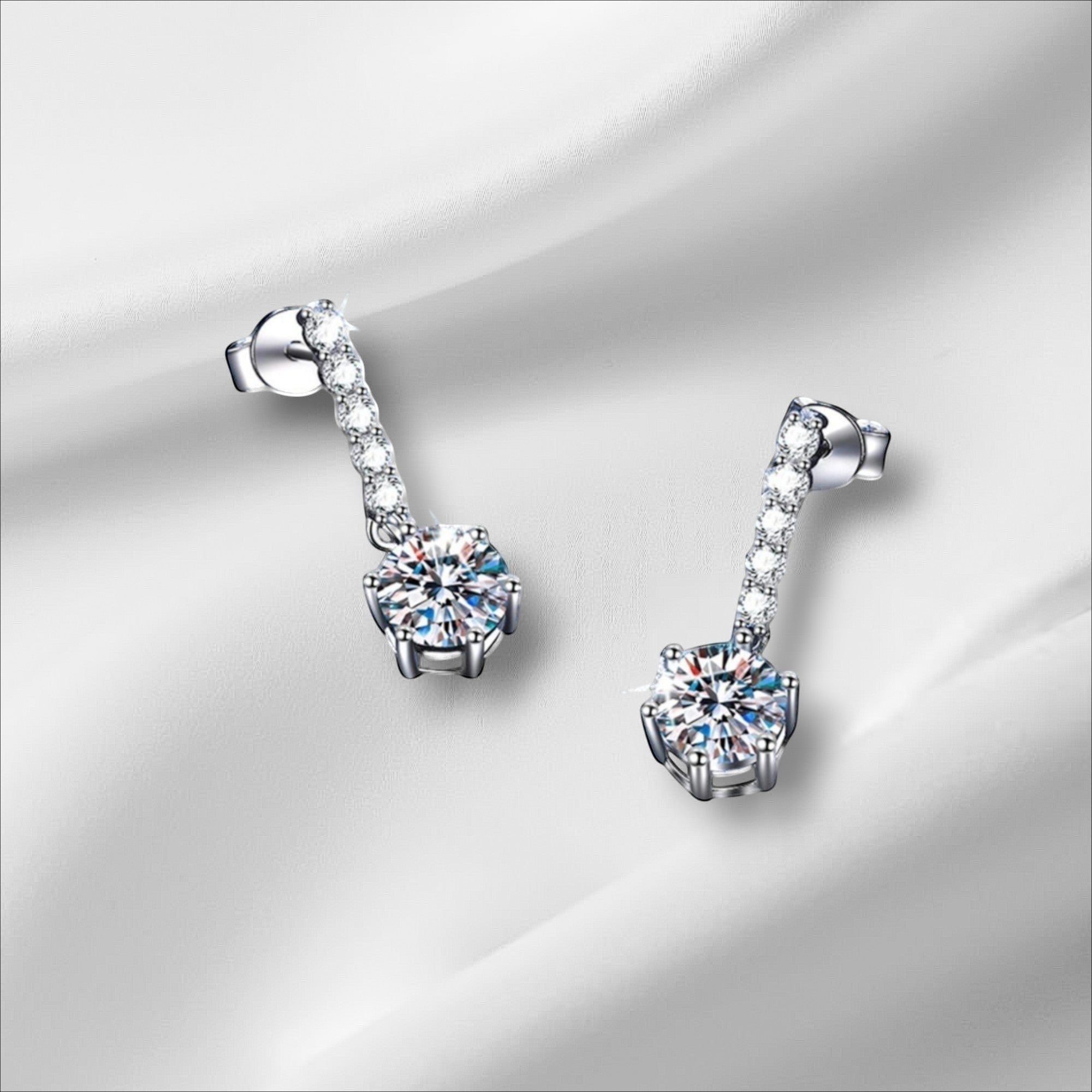 Bee-Bees 18k white gold plated sterling silver drop earrings with 1ct D Color Moissanite and zircon accents.