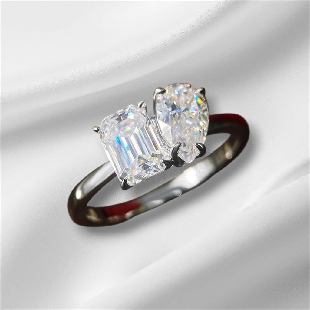 Bee-Bees engagement ring with emerald-cut and pear-cut D VVS1 moissanite stones in S925 silver with 18K white gold plating.