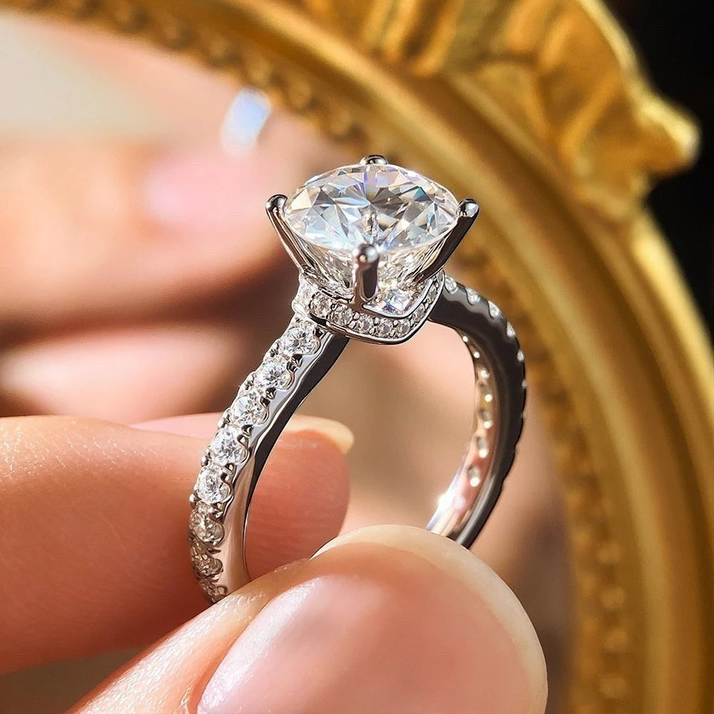Bee-Bees 1.5ct Moissanite engagement ring in s925 Sterling Silver with 18k gold plating, featuring a round brilliant-cut center stone and pavé band.