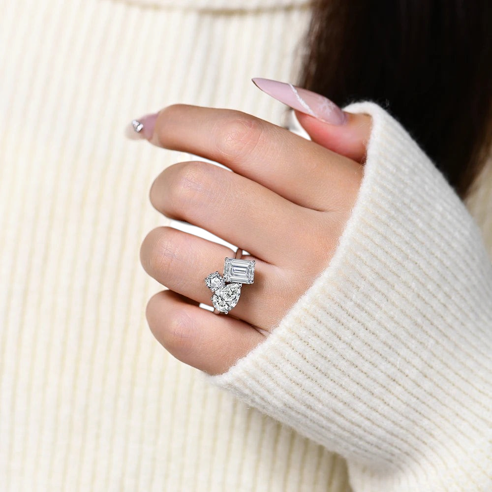 Bee-Bees 5.5CT moissanite engagement ring featuring pear and emerald cut stones on a 925 sterling silver band
