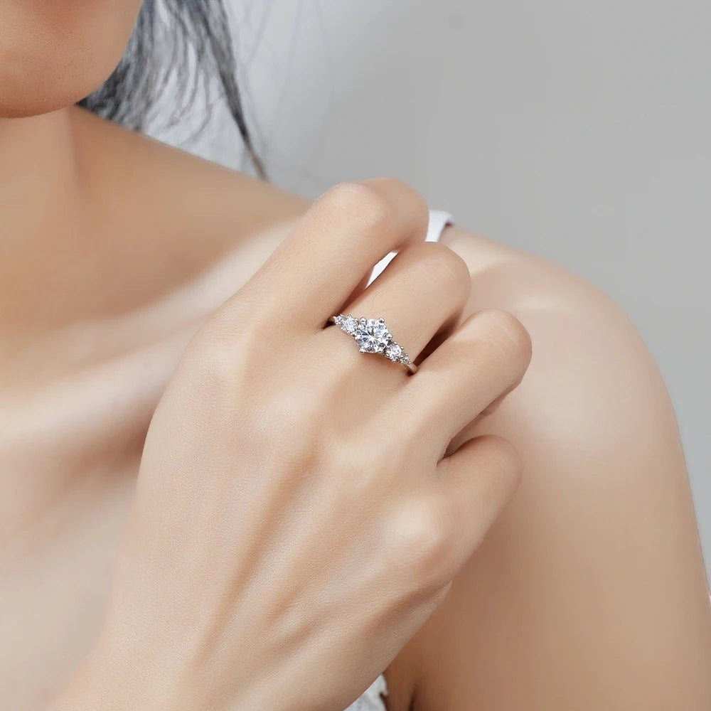Bee-Bees 1ct round moissanite engagement ring in s925 sterling silver with 18k white gold plating. Classic solitaire style with 6-prong setting.