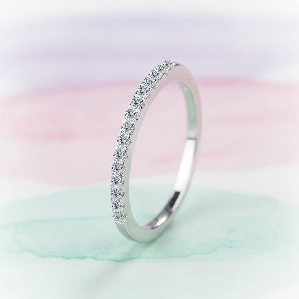 Bee-Bees 2mm D Color Moissanite eternity band in sterling silver with 18k white gold plating. Full circle of sparkling stones.