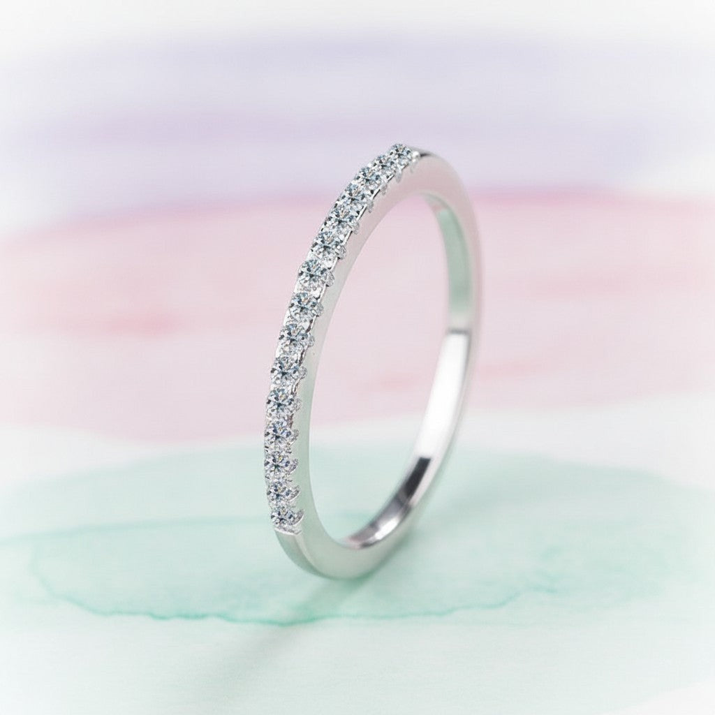 Bee-Bees 2mm D Color Moissanite eternity band in sterling silver with 18k white gold plating. Full circle of sparkling stones.