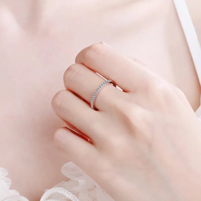 Bee-Bees 2mm D Color Moissanite eternity band in sterling silver with 18k white gold plating. A delicate, full circle of sparkling stones.