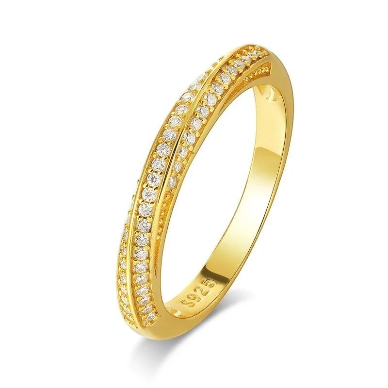 Bee-Bees 1mm Moissanite eternity band in 925 sterling silver with 18K white gold plating. Features pave-set, round-cut stones.