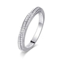 Bee-Bees 1mm Moissanite eternity band in 925 sterling silver with 18k white gold plating. Features pave-set round brilliant cut stones.