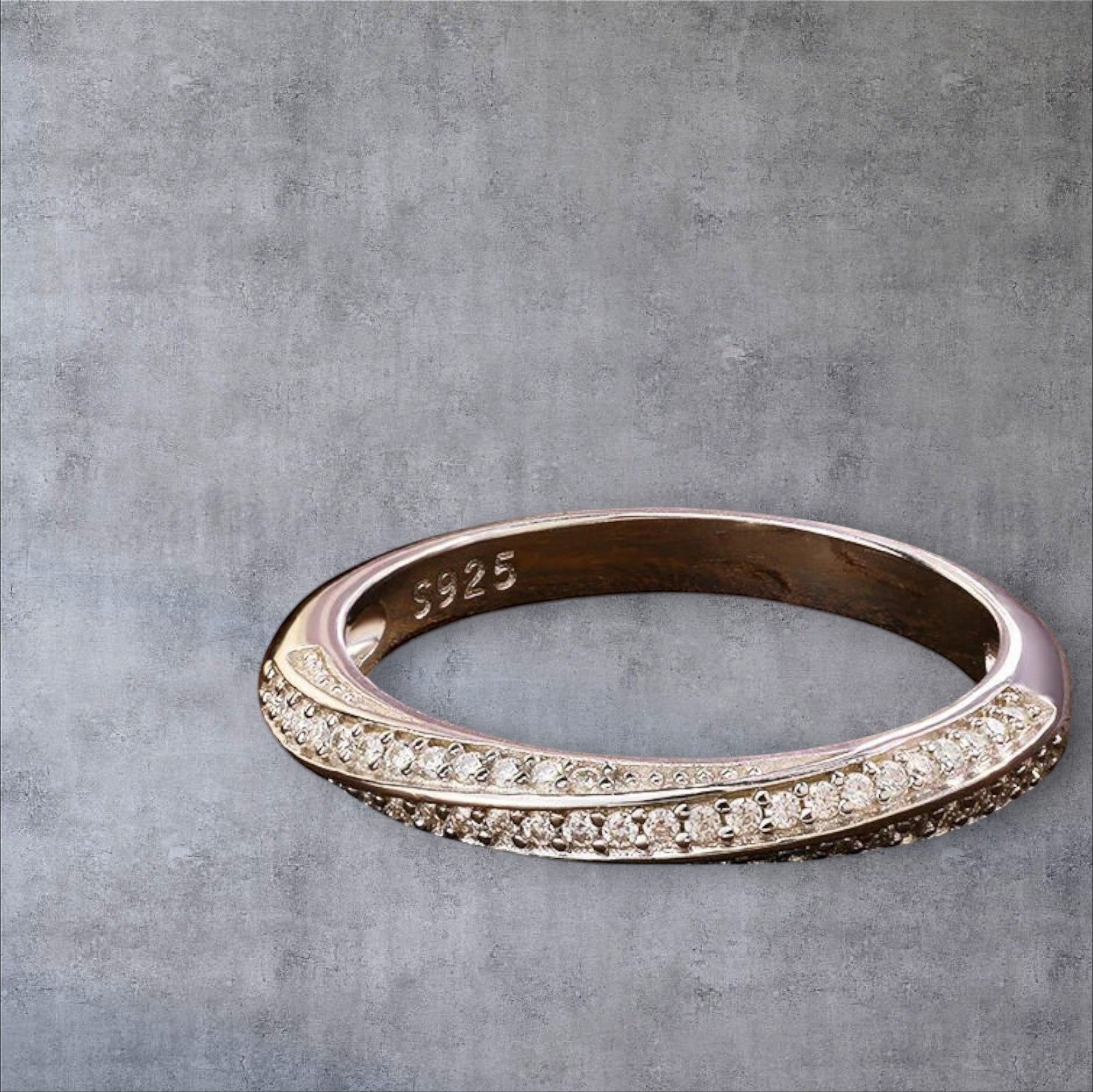 Bee-Bees 1mm Moissanite eternity band in 925 sterling silver with 18k white gold plating. Features a full circle of tiny, sparkling stones.