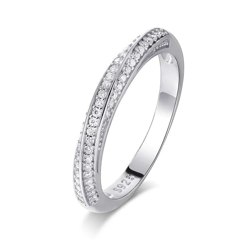 Bee-Bees 1mm Moissanite eternity band in 925 sterling silver with 18k white gold plating. Features pave-set round brilliant cut stones.