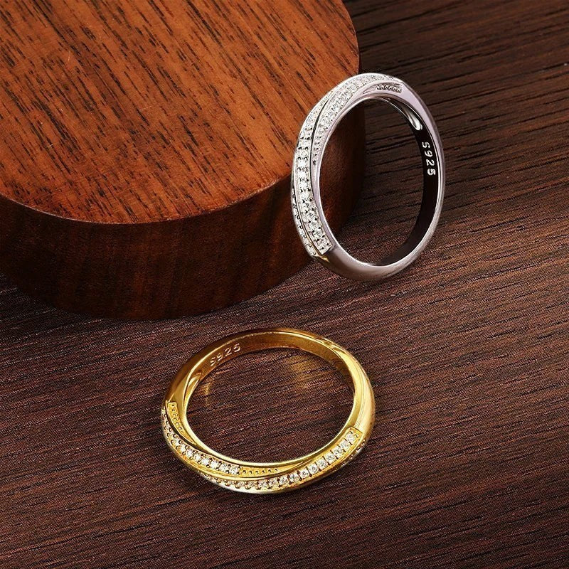 Bee-Bees 1mm Moissanite eternity band in 925 sterling silver with 18K white gold plating. Two rings shown: one gold, one silver, both with pave-set stones.