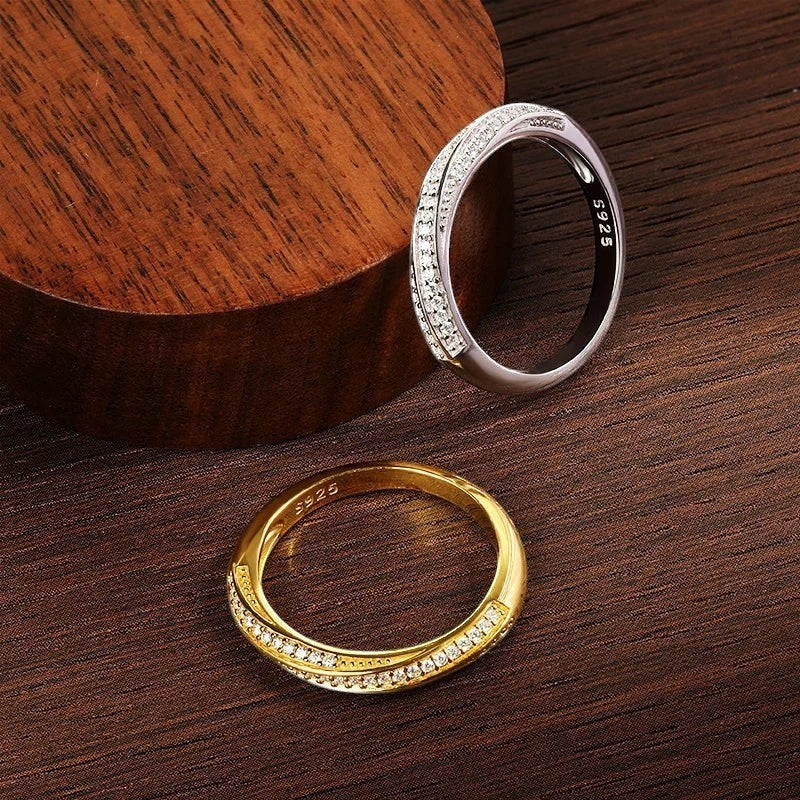 Bee-Bees 1mm Moissanite eternity band in 925 sterling silver with 18K white gold plating. Two rings shown: one gold, one silver, both with pave-set stones.