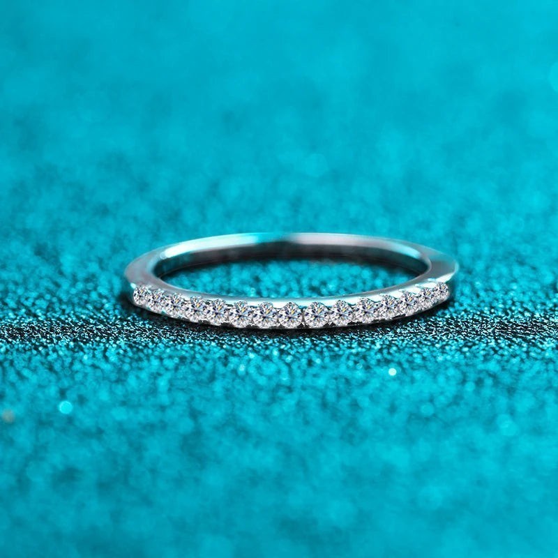 Bee-Bees 2mm D Color Moissanite eternity band in sterling silver with 18k white gold plating. Full circle of sparkling stones.