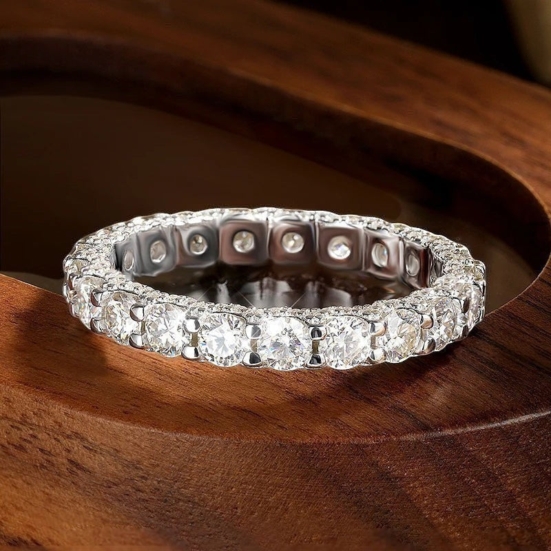 Bee-Bees 2.5ctw round moissanite full eternity band in 18k white gold plated sterling silver with D color VVS1 clarity stones.