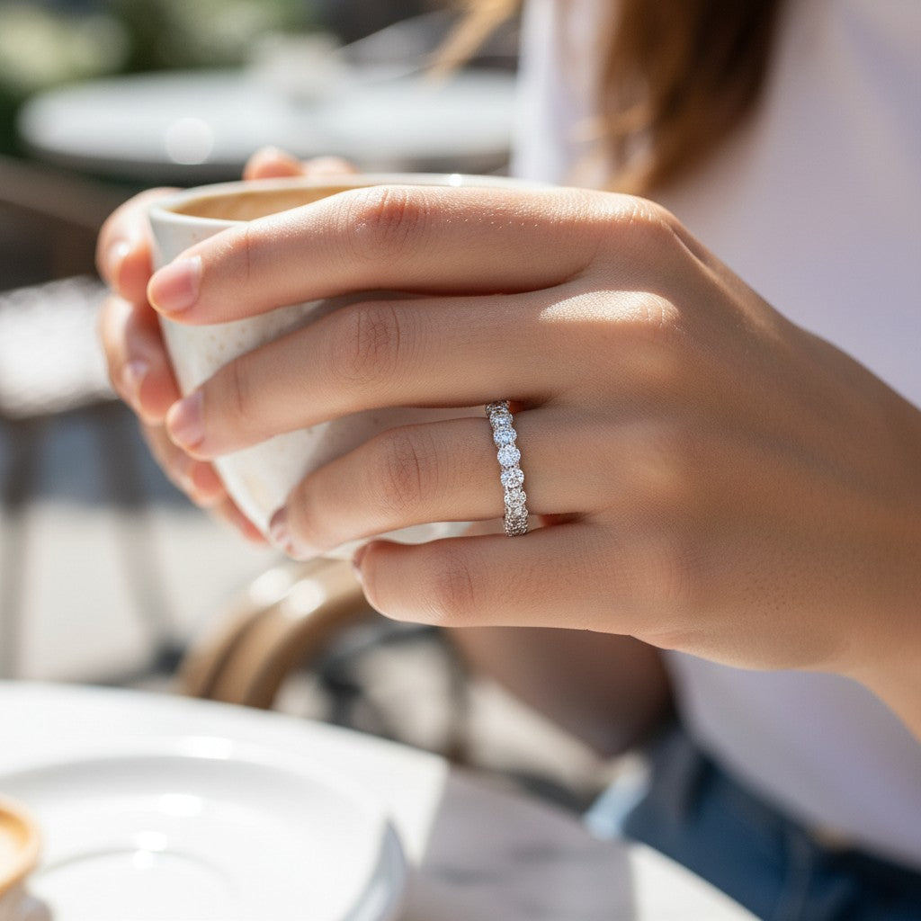Bee-Bees 2.5ct round moissanite full eternity band in 18k white gold plated S925 silver worn on a woman's finger.