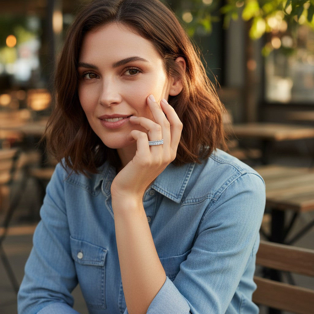 A woman wearing a Bee-Bees full eternity moissanite wedding band in 18k white gold plated sterling silver.