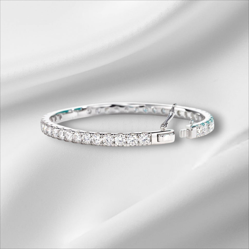 Bee-Bees 11.7ctw Moissanite eternity bangle in sterling silver with 18k white gold plating. Features 4mm round-cut stones and a secure clasp.