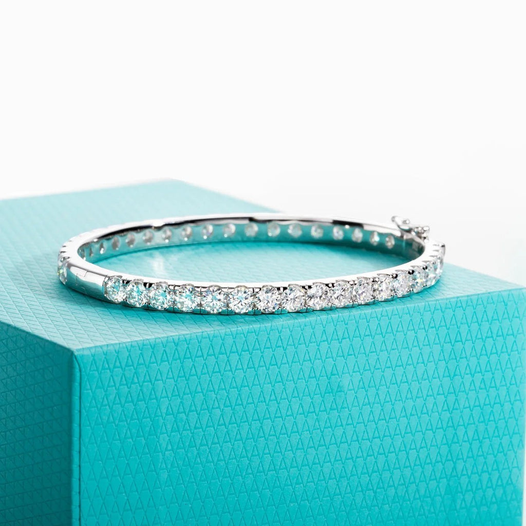 Bee-Bee's 11.7ctw Moissanite eternity bangle in sterling silver with 18k white gold plating. Features 4mm round-cut stones.