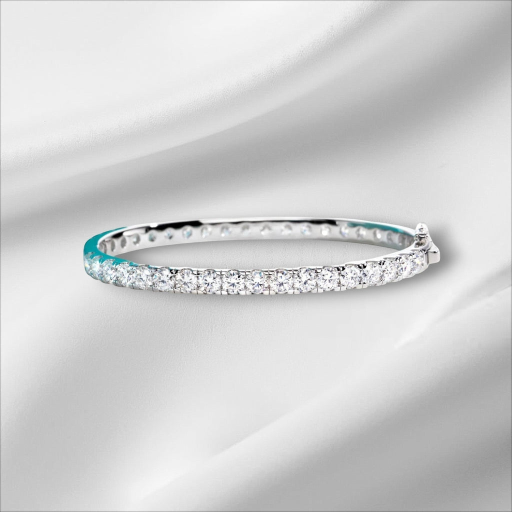 Bee-Bees 11.7ctw Moissanite eternity bangle in sterling silver with 18k white gold plating and a secure clasp.