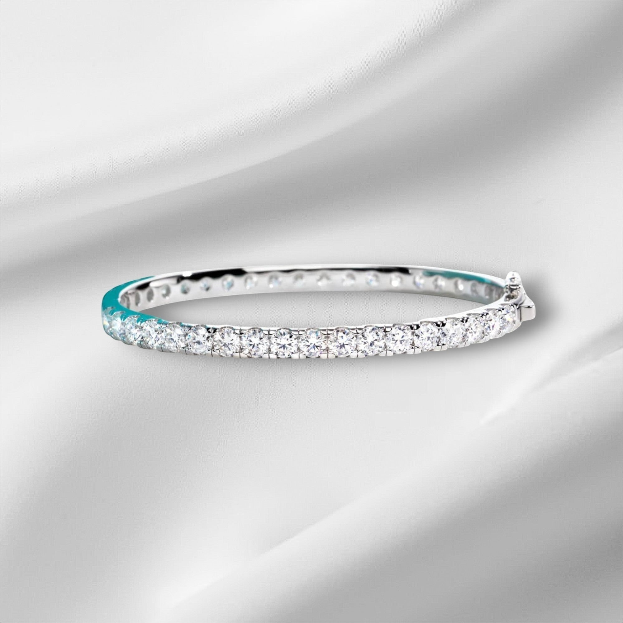 Bee-Bees 11.7ctw Moissanite eternity bangle in sterling silver with 18k white gold plating and a secure clasp.