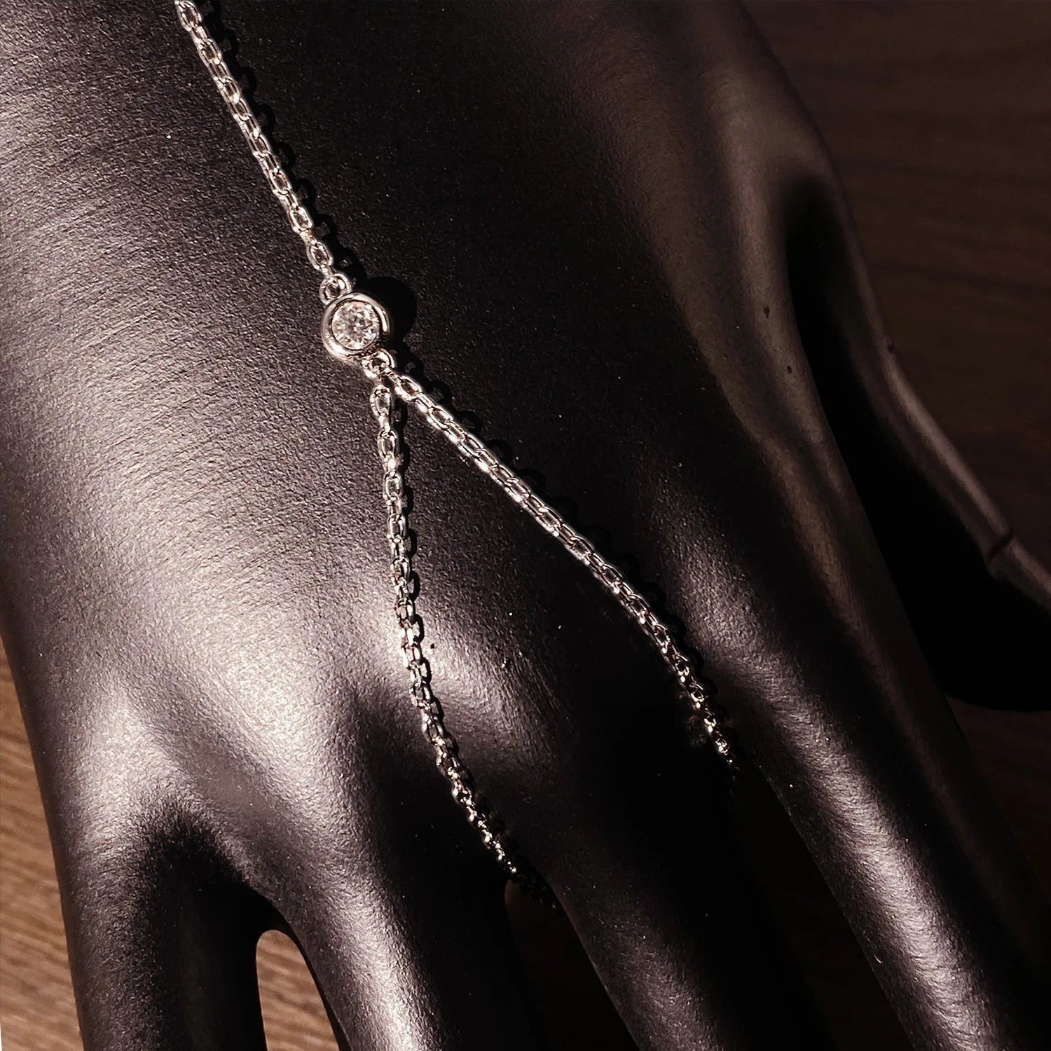 Bee-Bees 3mm moissanite finger bracelet in 925 sterling silver with 18k white gold plating, adjustable hand chain with single stone.