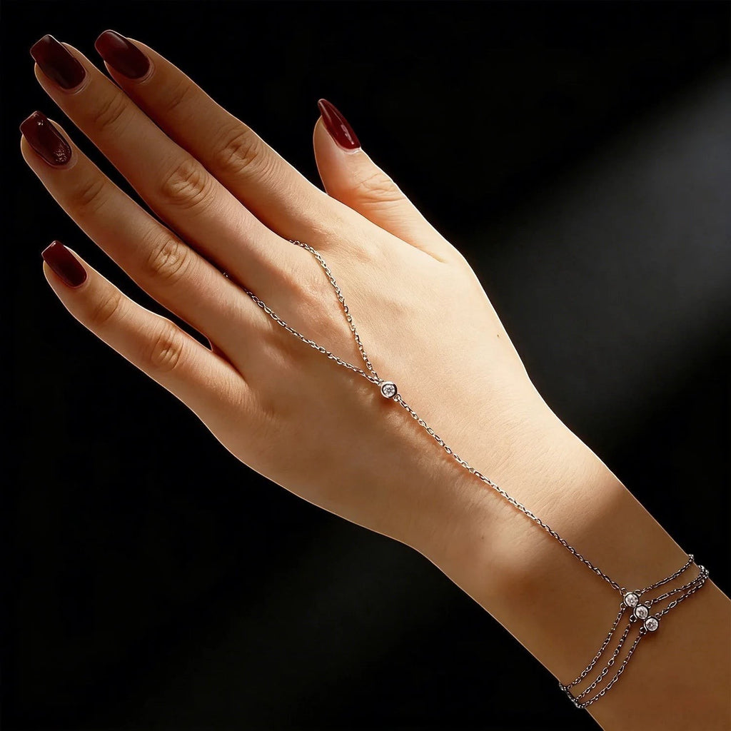 Bee-Bees 925 sterling silver adjustable hand chain bracelet with a 3mm moissanite stone and three small stones at the wrist.