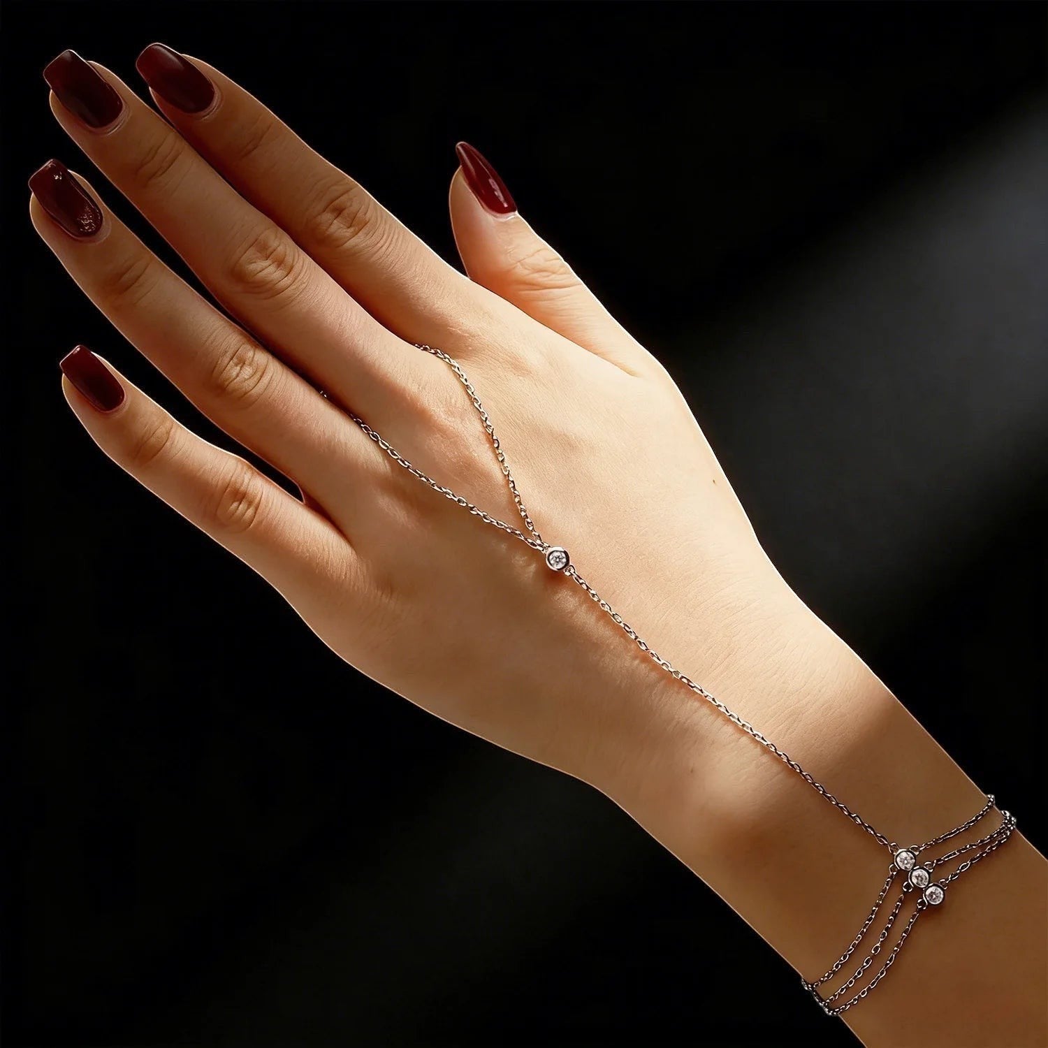 Bee-Bees 925 sterling silver adjustable hand chain bracelet with a 3mm moissanite stone and three small stones at the wrist.