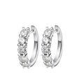 Bee-Bees white gold plated sterling silver hoop earrings with 3mm & 4mm D color moissanite stones.