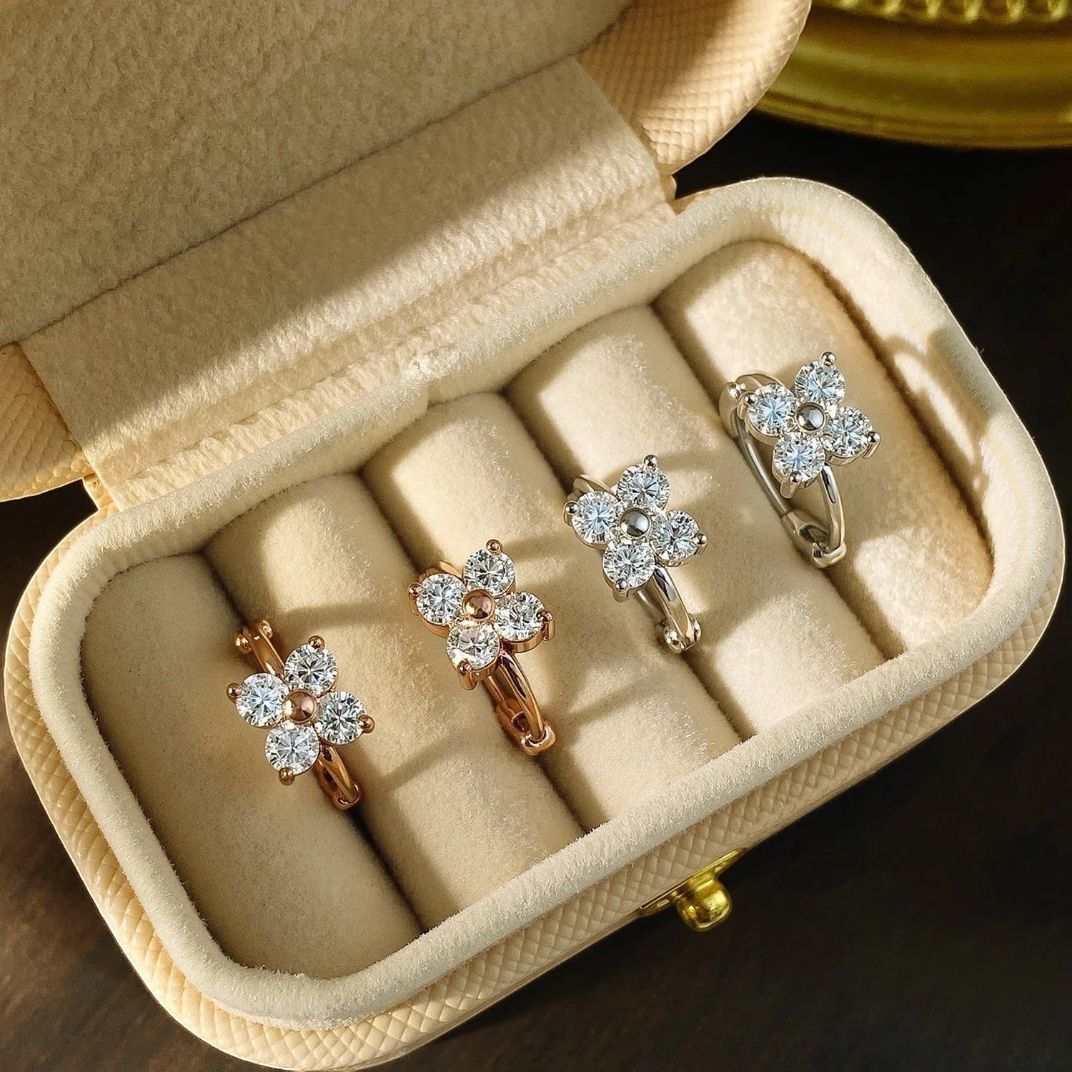 Bee-Bee's 3mm moissanite hoop earrings in rose gold and silver, featuring a flower design with clear VVS1 stones.