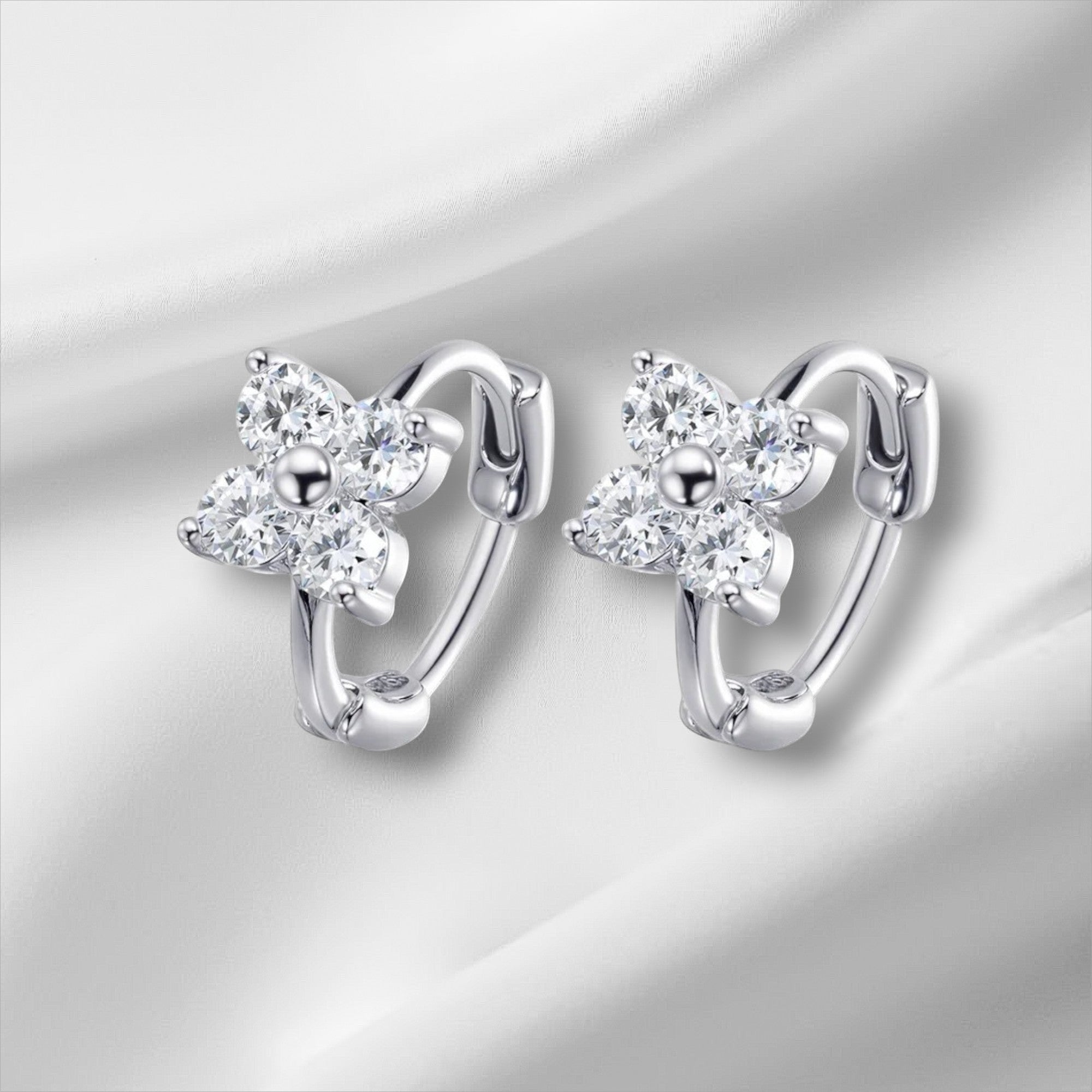 Bee-Bee's 3mm moissanite hoop earrings in sterling silver with a flower design, D color, VVS1 clarity.