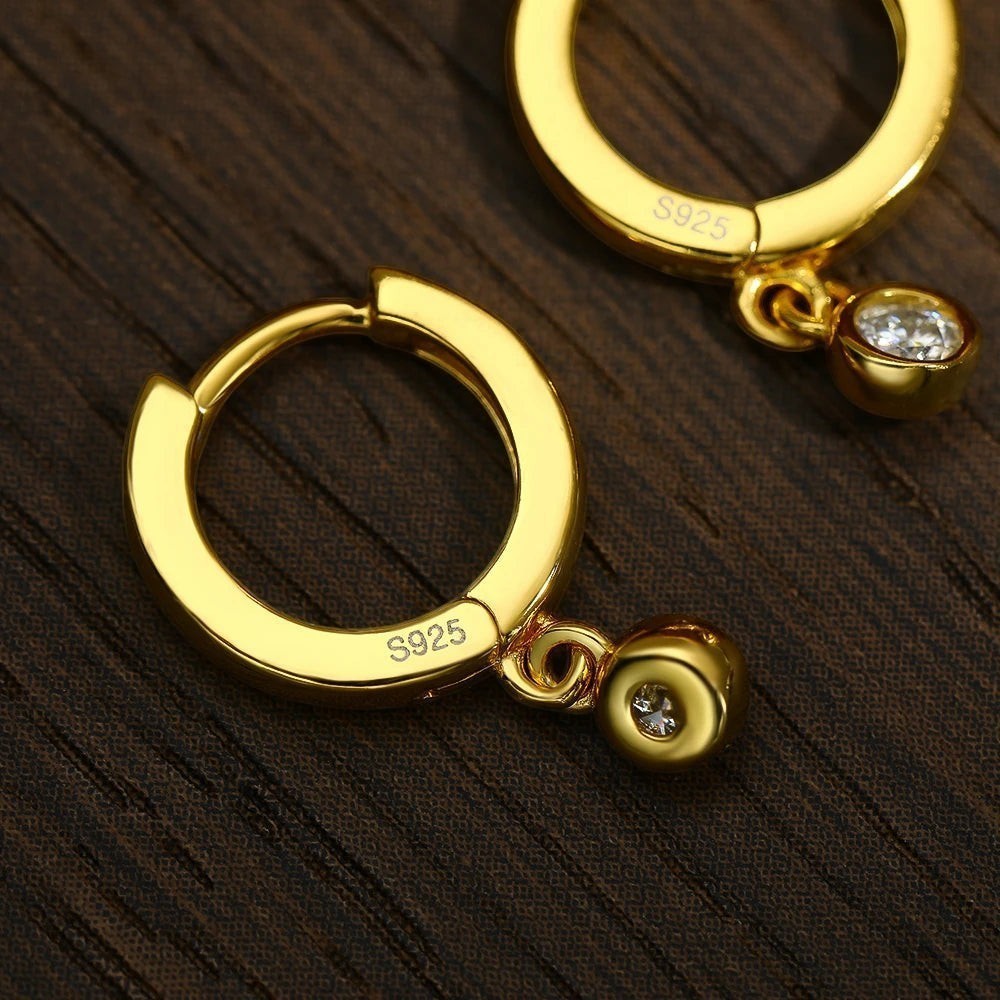 Bee-Bee's gold plated sterling silver hoop earrings with a single moissanite drop pendant. S925 stamped.