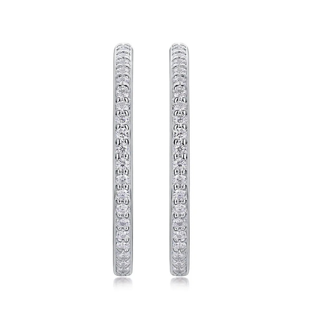 Bee-Bees 1.5mm D Color Moissanite Hoop Earrings. Sterling silver with white gold plating and pave-set round brilliant-cut stones.
