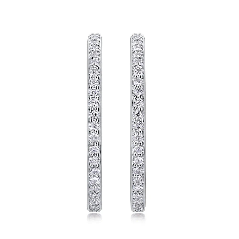 Bee-Bees 1.5mm D Color Moissanite Hoop Earrings. Sterling silver with white gold plating and pave-set round brilliant-cut stones.
