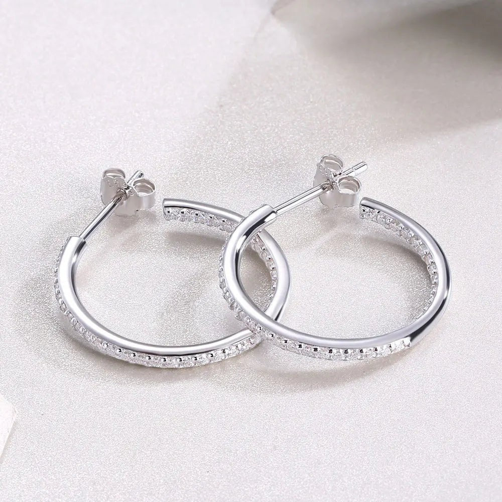 Bee-Bees dainty 1.5mm D color moissanite hoop earrings in sterling silver with white gold plating and secure click-to-lock closure.
