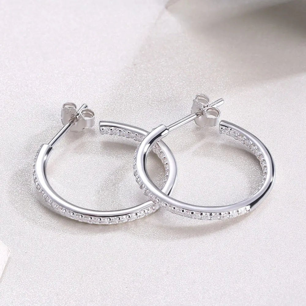 Bee-Bees dainty 1.5mm D color moissanite hoop earrings in sterling silver with white gold plating and secure click-to-lock closure.