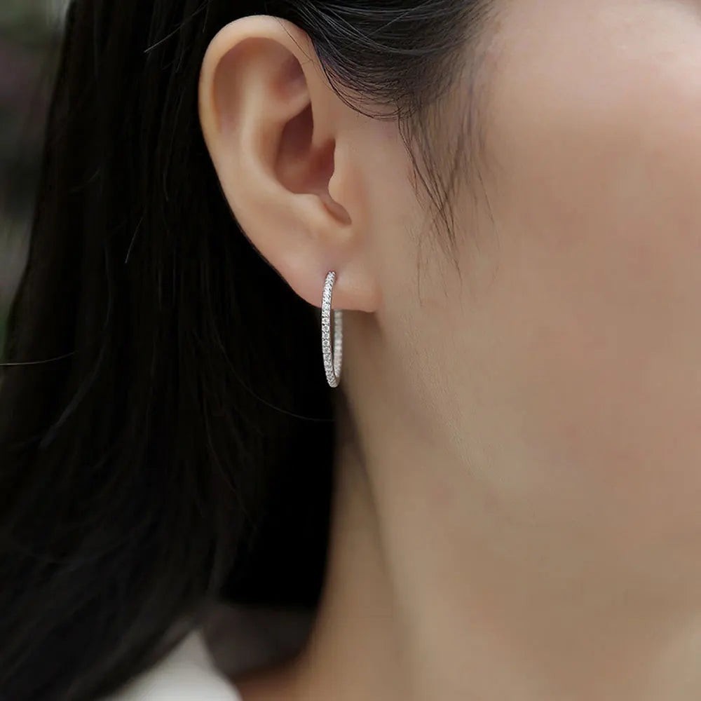 Bee-Bees dainty 1.5mm D color moissanite hoop earrings in S925 silver with white gold plating.