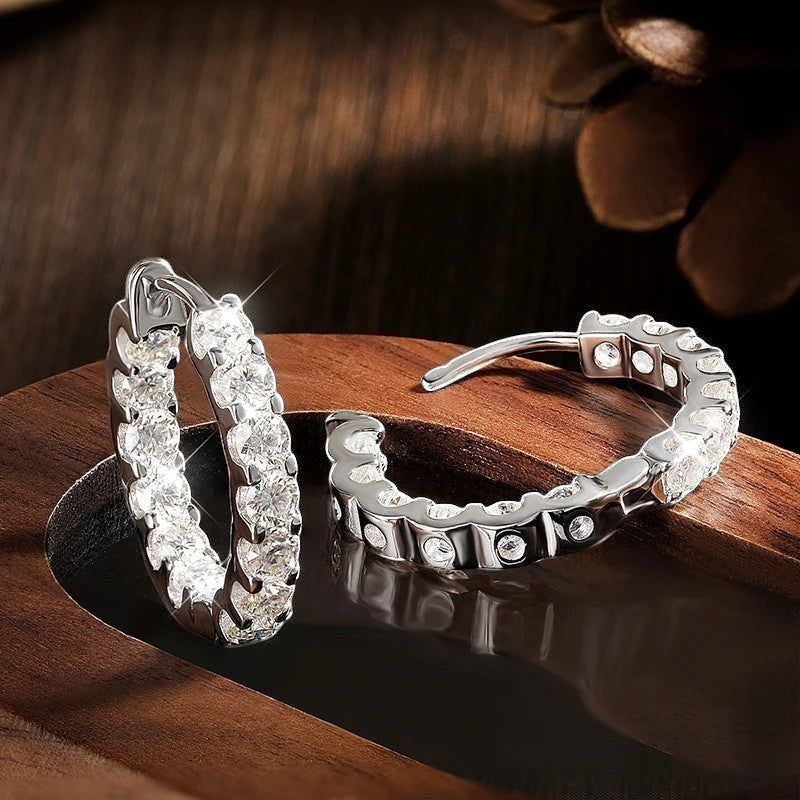 Bee-Bees 2.6ctw Moissanite eternity hoop earrings in 18k white gold plated silver with secure latch backing.
